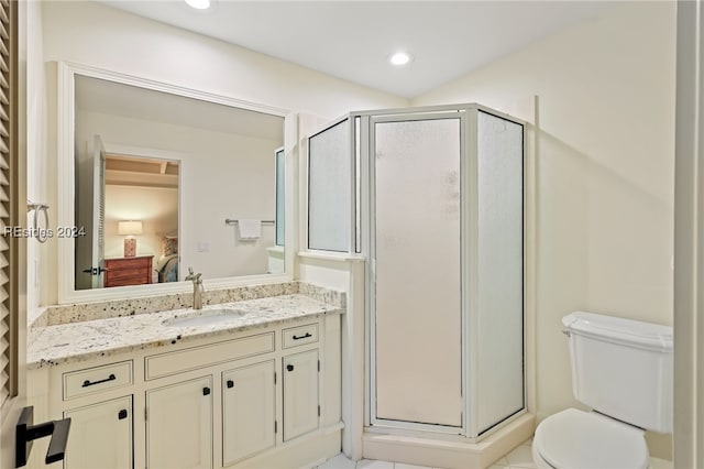 bathroom featuring vanity, toilet, and walk in shower