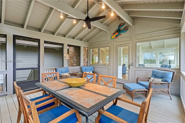 sunroom / solarium with rail lighting, vaulted ceiling with beams, wooden ceiling, and ceiling fan