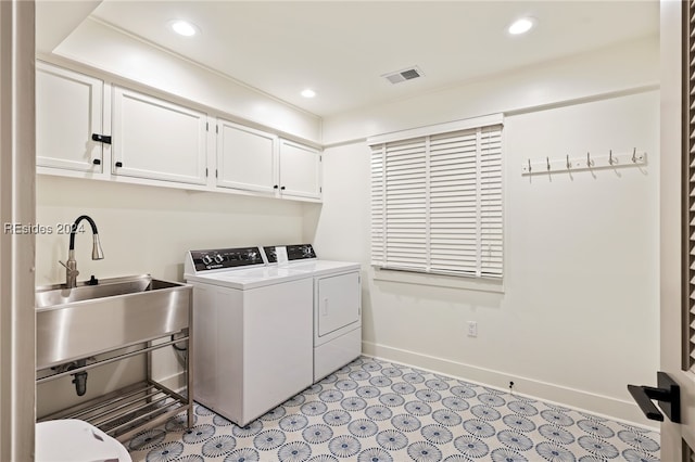 laundry area with independent washer and dryer, sink, and cabinets