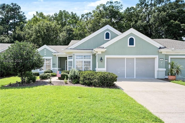 view of front of property featuring a garage and a front yard