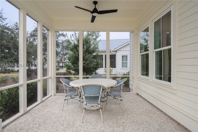 sunroom featuring ceiling fan