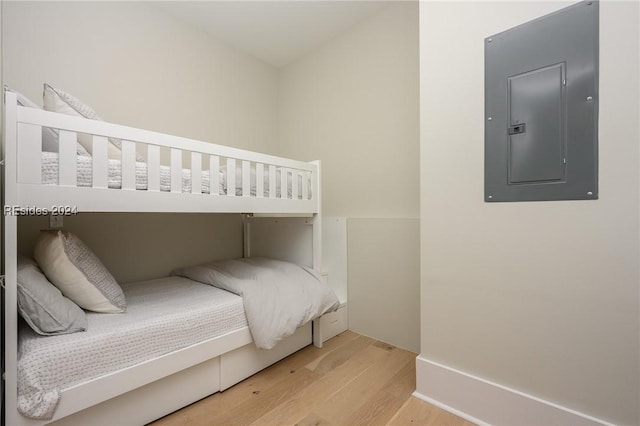 bedroom featuring wood-type flooring and electric panel