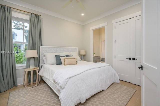 bedroom with multiple windows, ornamental molding, hardwood / wood-style floors, and ceiling fan