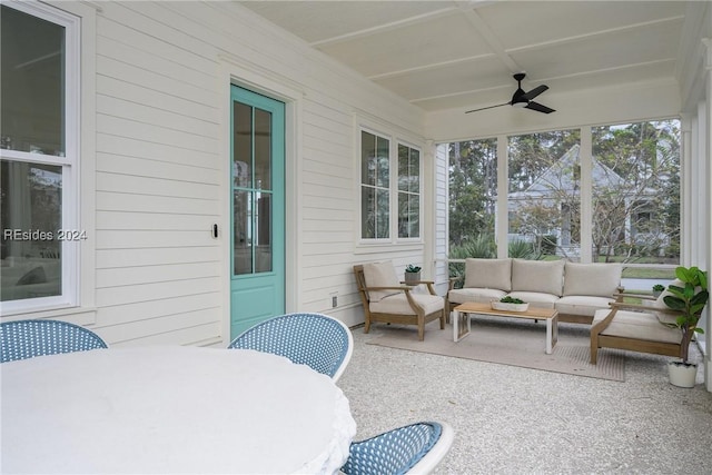 sunroom featuring ceiling fan