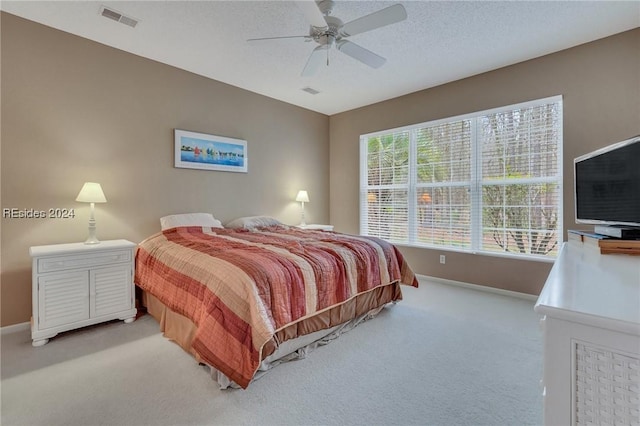 bedroom with light colored carpet and ceiling fan