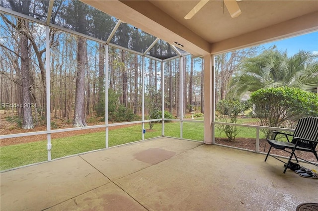 unfurnished sunroom featuring ceiling fan