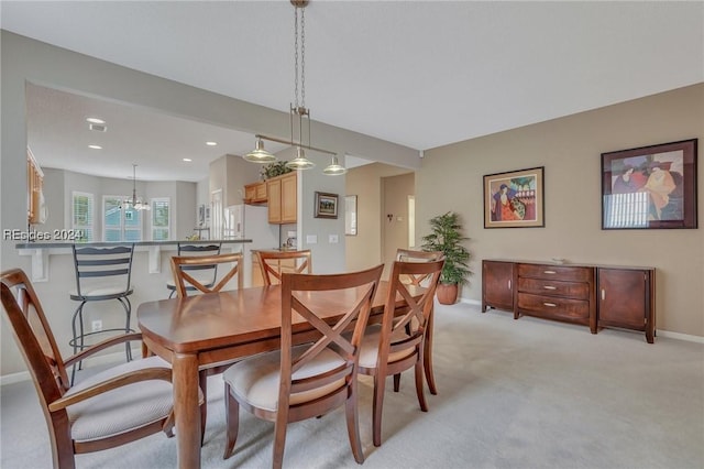 dining space featuring light carpet