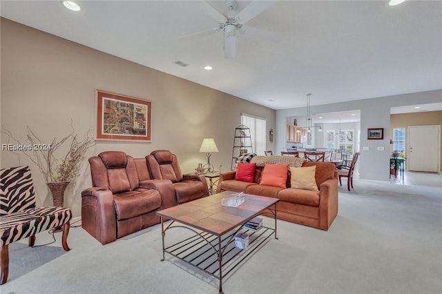 carpeted living room featuring ceiling fan