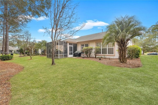 rear view of house featuring a yard