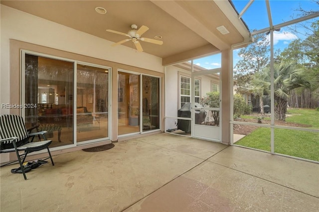 unfurnished sunroom featuring plenty of natural light and ceiling fan