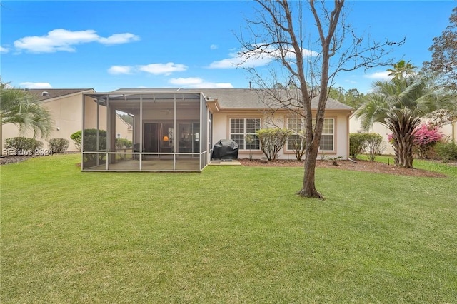 back of house with glass enclosure and a lawn