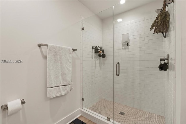 bathroom featuring a shower with door