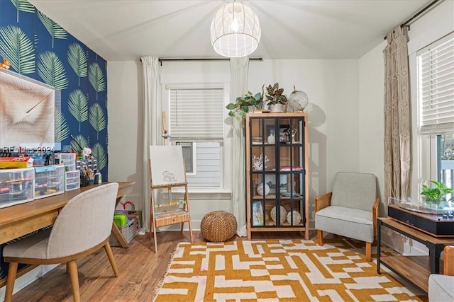 living area with a chandelier and light wood-type flooring