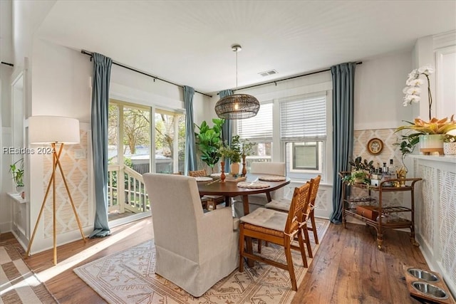 dining space featuring wood-type flooring