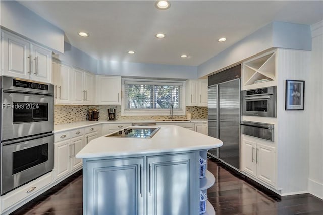 kitchen with stainless steel appliances, a center island, and white cabinets