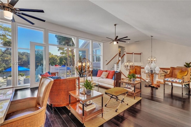 living room with lofted ceiling, dark wood-type flooring, and ceiling fan with notable chandelier