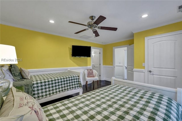 bedroom featuring hardwood / wood-style floors, ornamental molding, and ceiling fan