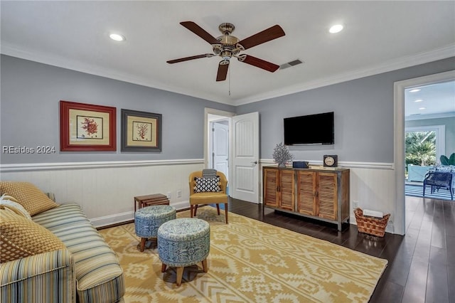 living room featuring crown molding, ceiling fan, and dark wood-type flooring