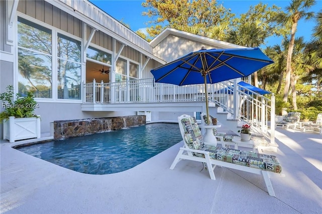 view of swimming pool with a patio and pool water feature