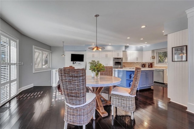 dining space with dark hardwood / wood-style floors