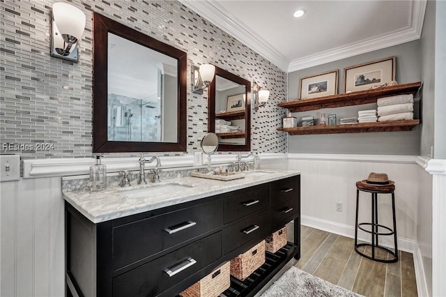 bathroom featuring crown molding, vanity, and walk in shower