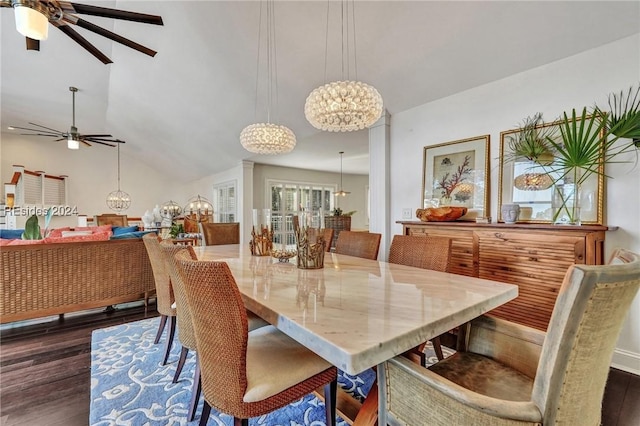 dining space featuring vaulted ceiling, dark wood-type flooring, and ceiling fan with notable chandelier