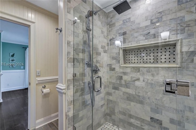 bathroom with ornamental molding, wood-type flooring, and walk in shower