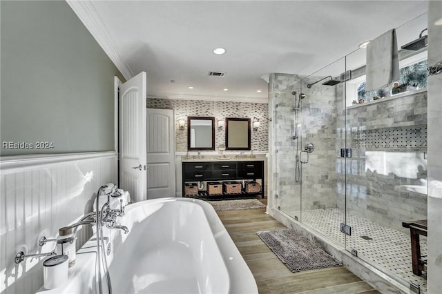 bathroom featuring vanity, shower with separate bathtub, hardwood / wood-style floors, and ornamental molding