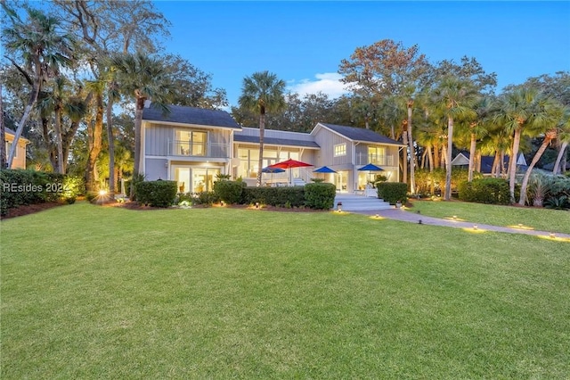 split foyer home featuring a balcony and a front yard