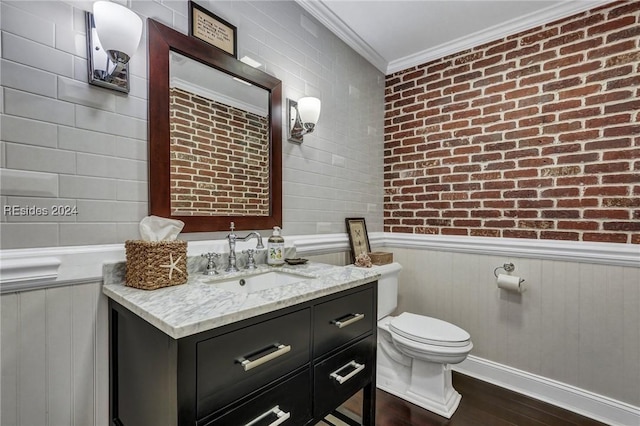 bathroom featuring vanity, crown molding, wood-type flooring, and toilet