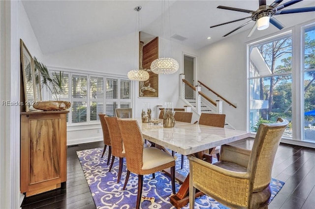 dining room featuring ceiling fan, dark hardwood / wood-style flooring, and vaulted ceiling