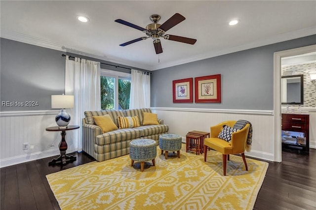 living room featuring crown molding, dark wood-type flooring, and ceiling fan