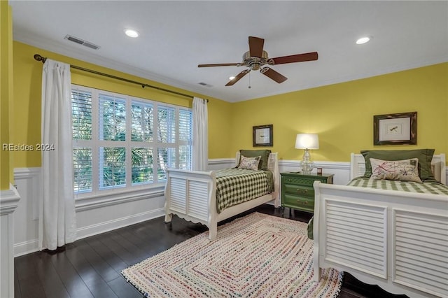 bedroom featuring crown molding, dark hardwood / wood-style floors, and ceiling fan