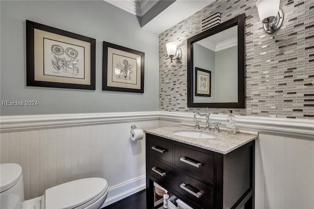 bathroom featuring vanity, ornamental molding, and toilet