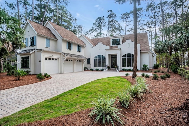 view of front of house featuring a garage and a front yard