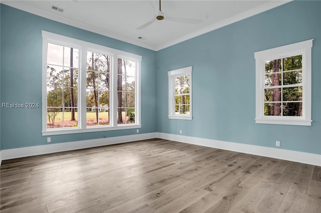 empty room featuring crown molding, ceiling fan, and light hardwood / wood-style flooring