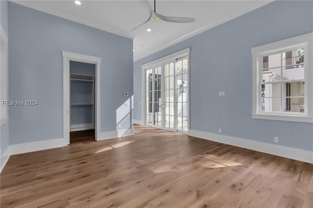 unfurnished room featuring hardwood / wood-style floors, ornamental molding, and ceiling fan