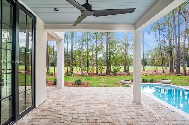 view of pool with ceiling fan, a yard, and a patio area