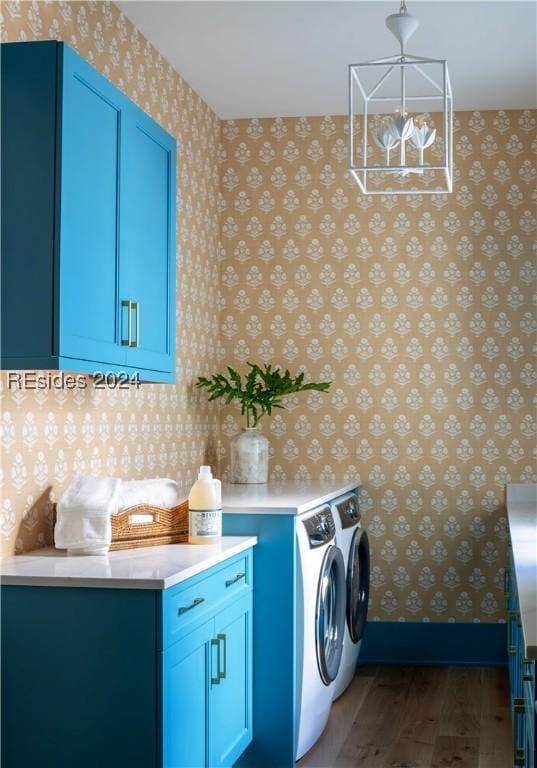 laundry room featuring cabinets, washing machine and dryer, and dark wood-type flooring