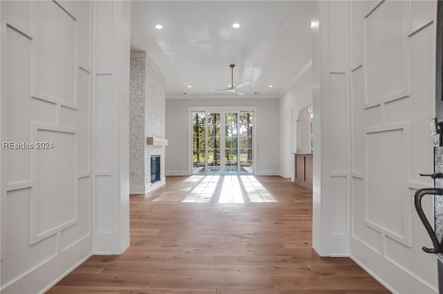 hall with crown molding and wood-type flooring