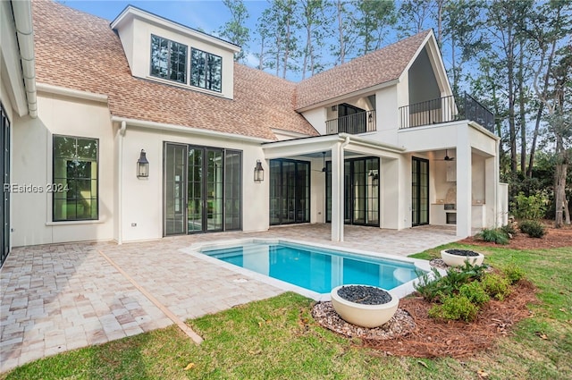 back of house with a balcony and a patio area