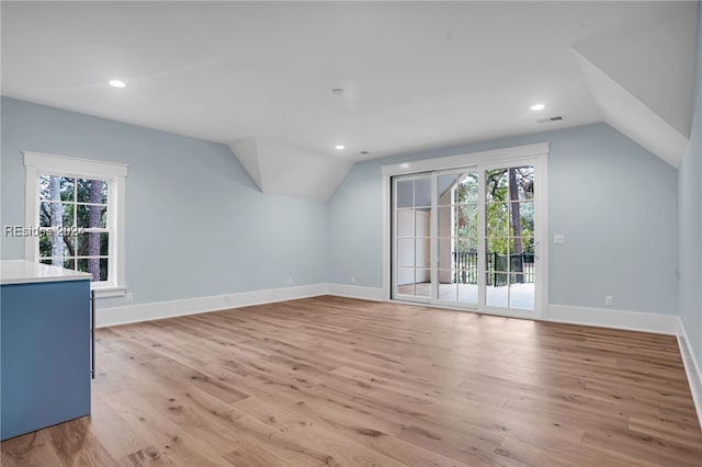 bonus room with lofted ceiling and light hardwood / wood-style flooring