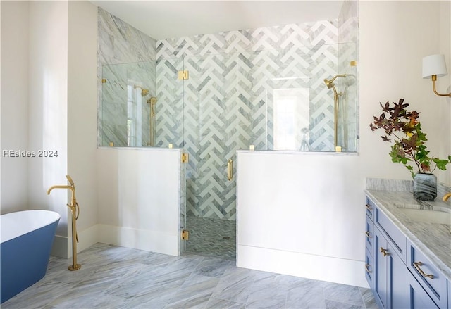 bathroom with vanity and separate shower and tub