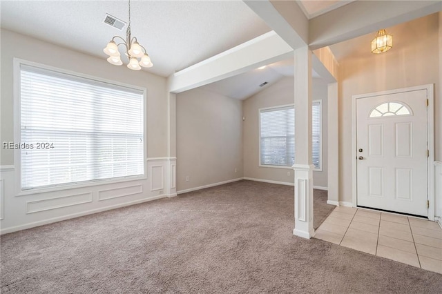 foyer featuring an inviting chandelier, vaulted ceiling with beams, and light colored carpet