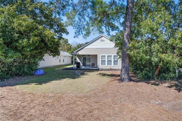 back of property featuring a lawn