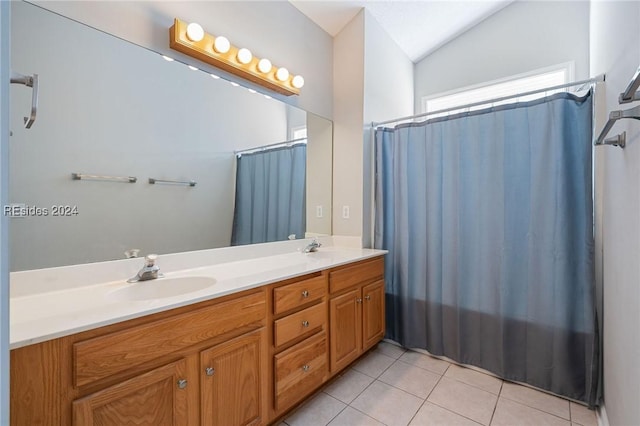 bathroom featuring tile patterned flooring, vanity, curtained shower, and vaulted ceiling