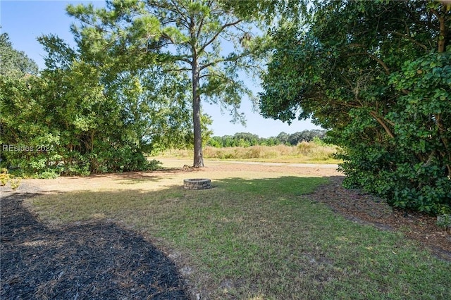 view of yard with a fire pit