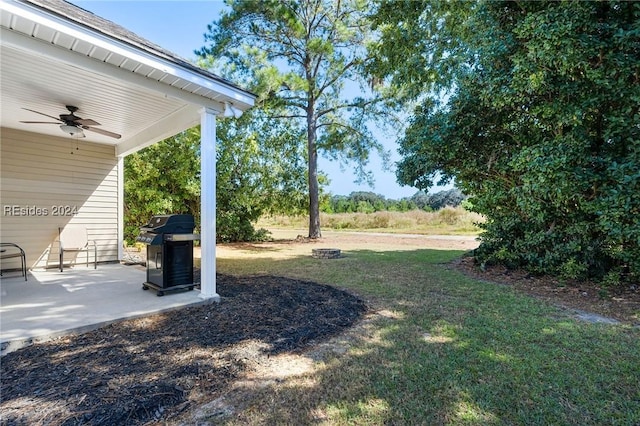 view of yard featuring ceiling fan and a patio area