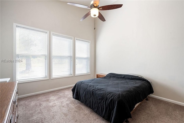 bedroom featuring light colored carpet and ceiling fan