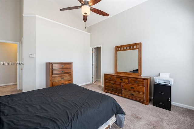 carpeted bedroom with high vaulted ceiling and ceiling fan